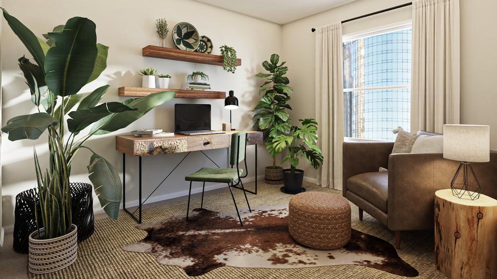 un oridnateur sur un bureau avec fauteuil et plantes vertes